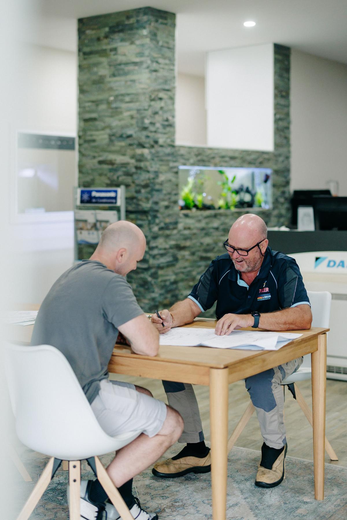A customer talking through a quote at the showroom table