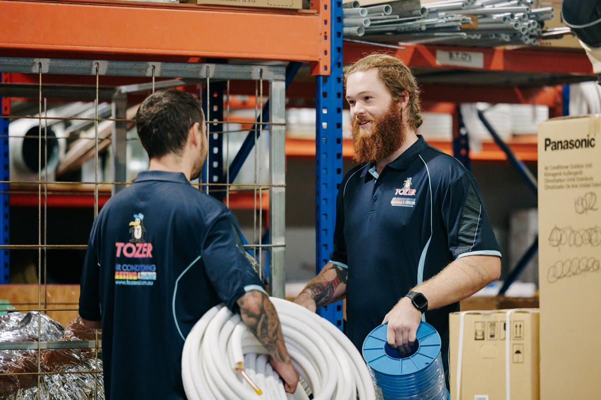 Technicians picking ducting in the warehouse