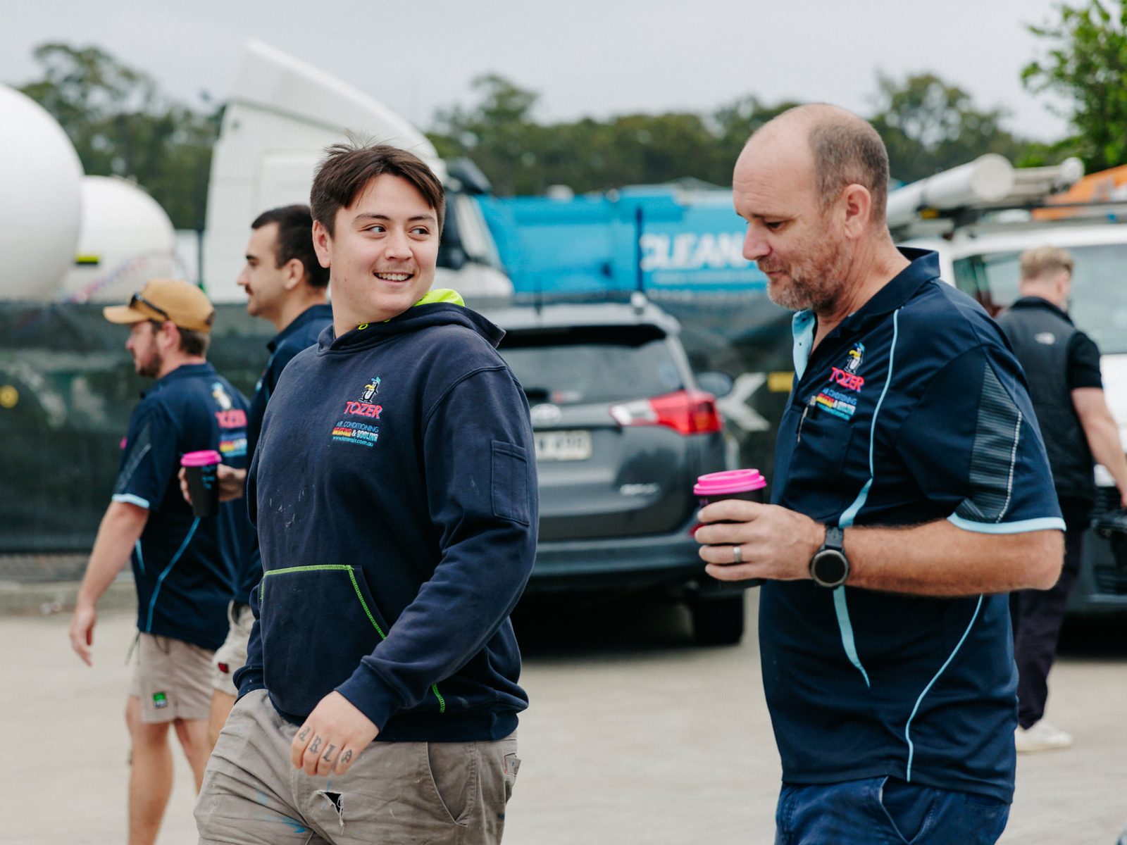 Two of the TOZER crew sharing a laugh over a coffee in the Beresfield yard