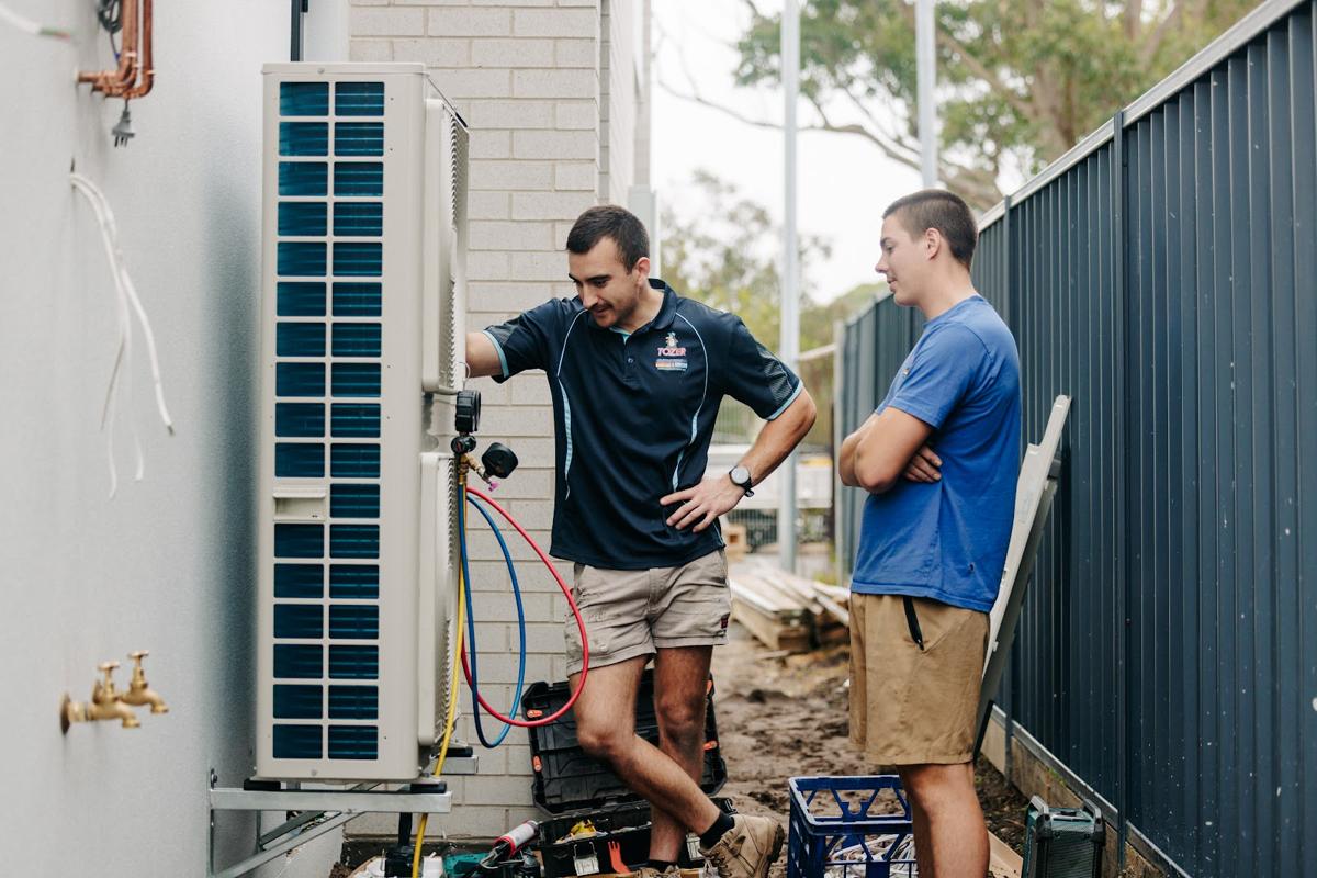 Two technicians commissioning an outdoor unit together